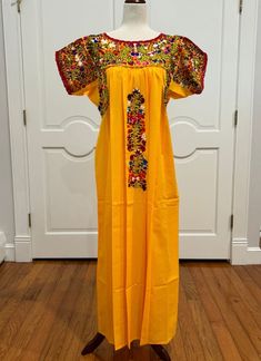 Handmade embroidered Dress is from San Antonino Castillo Velasco region of Oaxaca, Mex. each Dress is one-of-a-kind and characterized by its vibrant colors, detailed with silk embroidery, in front and the back and crochet work. PC # E-815 COLORS: Yellow with multi color silk embroidery. MATERIAL; Poplin with Silk embroidery APPROXIMATE MEASUREMENTS. Around bust 48'' Shoulder to bottom hem 53" Boho, bohemian, handmade, Mexico, Hippie, Embroidery, Vintage, Tunic, One of A Kind. Artisan Made, Ethnic Floral, Vintage Style. https://www.etsy.com/shop/BellaEmbroidered?ref=profile_header Embroidered Multicolor Maxi Kaftan, Multicolor Folk Dress With Intricate Embroidery, Multicolor Embroidered Cotton Folk Kaftan, Multicolor Folk Dress With Embroidered Border, Yellow Embroidered Folk Dress, Mexican Dresses, Silk Embroidery, Silk Thread, Embroidered Dress