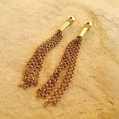 These gold tassel earrings created by Jewelry by CARMAL are made of gold filled: chain, beads earring hooks and findings. These earrings measure 4 inches in length. See more dangle earrings: http://www.etsy.com/shop/jewelrybycarmal?section_id=8002052 All of our jewelry comes wrapped and ready for gift giving! We also offer free standard shipping within the United States. We accept custom orders and would love to work with you! Please see other items in our shop: http://www.jewelrybycarmal.etsy.c Brass Chain Dangle Earrings, Yellow Gold Chain Brass Earrings, Brass Chain Earrings For Gift, Gift Chain Earrings In Brass, Gold Tassel Earrings With Dangling Beads, Gold Metal Jewelry With Tassels, Gold Metal Tassel Jewelry, Gold Chain Dangle Brass Earrings, Gold Chain Dangle Earrings In Brass