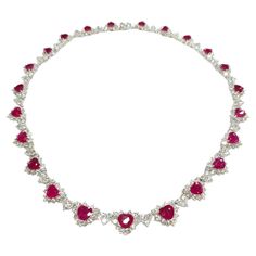 Prepare to make a statement with this breathtaking IGI certified 26.58ct Ruby & 17.85ct Natural Diamonds Necklace in 18K White Gold. Crafted with exquisite artistry and attention to detail, this extraordinary piece is a true masterpiece that showcases the mesmerizing beauty of rubies and diamonds. The focal point of this necklace is the 23 heart-shaped natural rubies, totaling 26.58 carats, each exuding a deep red hue that is synonymous with the finest Burmese rubies. Certified by IGI to ensure their origin from Burma, these rubies are renowned for their exceptional quality and lustrous color, making them a rare and coveted gemstone in the world of jewelry. Complementing the rubies are a total of 414 round brilliant diamonds, weighing 17.85 carats, meticulously set in heart-shaped patterns Luxury Bollywood Ruby Necklaces, Rubies And Diamonds, Ruby And Diamond Necklace, Burmese Ruby, Diamonds Necklace, Mesmerizing Beauty, Ruby Necklace, Ruby Diamond, Natural Ruby