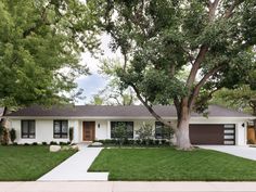 a white house with trees in front of it