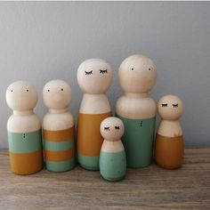 a group of wooden dolls sitting next to each other