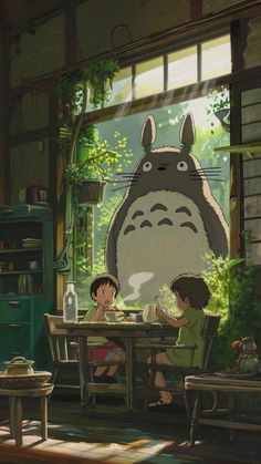 people sitting at a table in front of a window with the character totoro on it