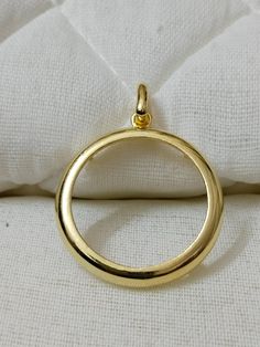 a gold ring sitting on top of a white pillow