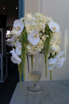 a vase filled with white flowers on top of a table