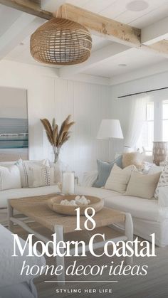 a living room filled with white furniture and lots of pillows on top of the couch