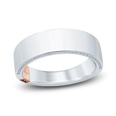 a white gold wedding ring with diamonds on the outside and rose gold in the inside