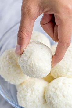 a person is picking up some food from a bowl