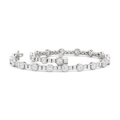 A testament to our vision of harmonizing luxury and simplicity. This tennis bracelet features a continuous line of round diamonds laid out in a pattern of one alternating bezel-set round diamond and a duo of claw prong-set round diamonds. The bracelet's understated design showcases the unparalleled fire and brilliance of the most popular diamond shape. Claw Prong, Floral Pendant, Continuous Line, Diamond Shape, Gold Platinum, Tennis Bracelet, A Pattern, Showcase Design, Three Stone