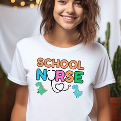 Cute School Nurse Tshirt: Discover cozy and stylish tees celebrating school nurses! Perfect for honoring their dedication or gifting to your favorite healthcare hero. Made from our BELLA AND CANVAS brand, this tee offers style and comfort. Here's what you need to know before you make your purchase: 1.Unisex Adult Sized Shirts. They're not women's fitted shirts, so for a more fitted look, consider sizing down. 2.Rolled Sleeves in pictures are for styling purposes only. 3.Props used in photos are NOT included with purchase. PRINT DESIGN 1.This is a Direct-To-Garment printed item, ensuring durability without cracking or peeling. 2.The ink is printed INTO the fabric, ensuring longevity. WASHING INSTRUCTIONS 1.Wash inside out, in cold water, on a gentle cycle. Tumble dry low or let air dry. 2.D Back To School Text Print Crew Neck T-shirt, Back To School Funny Text Short Sleeve T-shirt, Funny Graphic Print T-shirt For School, School Crew Neck T-shirt With Funny Text, Funny White T-shirt For Back To School, Funny Text Print T-shirt For School, Cute White T-shirt For College, Cute White College T-shirt, White Back To School T-shirt For College