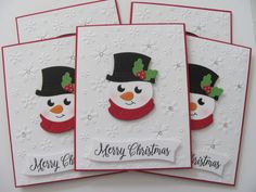 four christmas cards with snowmen on them