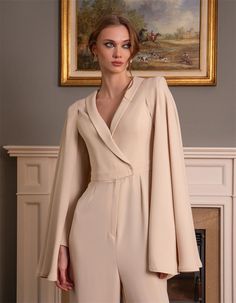 Step into sophistication with this stunning long-sleeve women's jumpsuit, featuring a gracefully flowing cape detail that adds a touch of drama to your look. Tailored to perfection, this jumpsuit is designed to flatter with its sleek silhouette and luxurious fabric. Whether you're attending a formal event, a wedding, or a special evening out, this elegant jumpsuit ensures you make a statement. The unique cape sleeves add an extra layer of elegance, making it a perfect choice for those who apprec Formal Jumpsuit With Cape, Jumpsuit Elegant Formal, Jumpsuit With Cape, Light Costume, Elegant Jumpsuit, Women's Jumpsuit, Bridesmaid Ideas, Formal Jumpsuit, Evening Jumpsuit