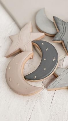 decorated cookies in the shape of stars and crescents on a white table with a gray background