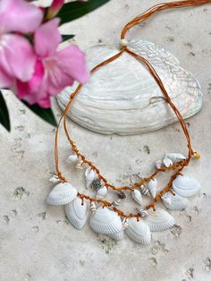 Discover the perfect blend of beachy elegance and boho charm with our Statement Seashell Choker Necklace. Handcrafted from natural white seashells, this unique piece is made for free spirits and beach lovers who want to carry a bit of the ocean with them wherever they go. 🌊 Whether you're dressing for a beach vacation, a seaside wedding, or simply adding a coastal touch to your everyday style, this natural seashell choker is designed to complement any look. Its minimalist, boho style makes it a Bohemian Shell Choker As Gift, Handmade Shell-shaped Choker, Handmade Shell-shaped Choker For The Beach, Summer Bohemian Shell-shaped Necklace, Bohemian Shell-shaped Beach Choker, Seashell Necklace, Seaside Wedding, Handcrafted Art, Boho Designs