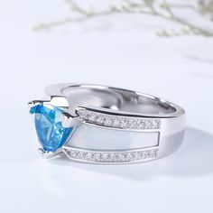 Unique but beautiful, this ring features its trillion-cut aquamarine blue center stone and the special design on the shank. The center stone captivates with brilliance from every angle and the shank shows special charm of the ring. Crafted in 925 sterling silver, decorated with round stone, the ring is of good quality and exquisite craft. If you are looking for unique jewelry for yourself or beloved one, just take this. It won't disappoint you.Carat Weight: 2.15 ctStone Size: 7*7 mmStone Type: Jeulia® StoneNumber of Stones: 1 Stone Color: Aquamarine BlueStone Shape: TrillionCarat Weight: 0.42 ctStone Size: 1 mmStone Type: Jeulia® StoneNumber of Stones: 42 Stone Color: Diamond WhiteStone Shape: RoundWeight: 5 gWidth: 8.1 mmHeight: 6.2 mmThickness: 4.2 mmMaterial: 925 SilverPlating Color: Si Formal Trillion Cut Topaz Ring In Fine Jewelry Style, Blue Topaz Trillion Cut Ring, Blue Trillion-cut Topaz Ring, Blue Trillion Cut Ring With Diamond Accents, Blue Trillion Cut Topaz Ring, Formal Trillion Cut Topaz Fine Jewelry Ring, Blue Trillion Cut Ring Fine Jewelry, Blue Trillion Cut Fine Jewelry Ring, Blue Trillion Cut Rings In Fine Jewelry