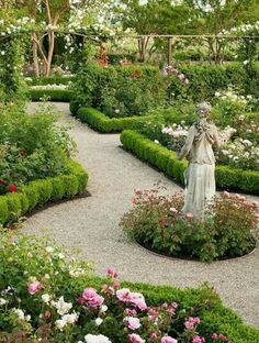 a garden with many different types of flowers and plants in the center, including roses