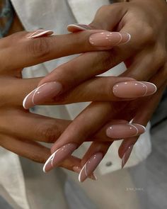 two hands with manicured nails holding each other