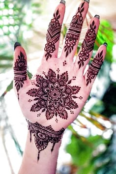 the hand is decorated with henna on it