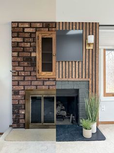 a living room with a fire place and a television mounted on the wall above it