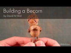 a person holding a tiny wooden bird in their hand with the words building a beacon above it