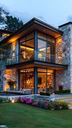 a large stone house lit up at night