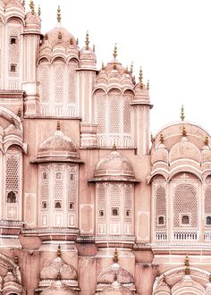 an artistic view of a building made out of pink colored bricks and stuccos with intricate carvings on the sides