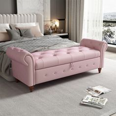 a bed with pink tufted upholstered headboard and footstool in a bedroom