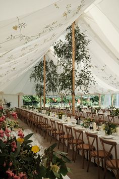 the inside of a tent with tables and chairs