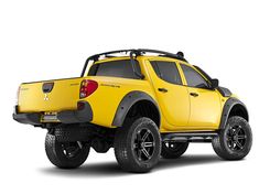 a yellow pick up truck parked in front of a white background