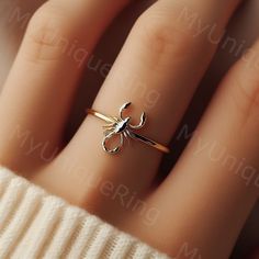 *Free engravings up to 20 characters* Embrace the mystique of the desert with this minimalist scorpion ring! 🌟 It's a bold adornment for your finger or an ideal gift for anyone who finds fascination in the unique and powerful symbolism of scorpions. 🦂💕 This ring is perfect for stacking or making a statement on its own, capturing the essence of the scorpion's resilience and striking presence. Meticulously crafted, it features a minimalist scorpion design along a delicate band, embodying the enigmatic spirit of the desert. Whether you're drawn to the intrigue of these creatures or seeking a distinct piece of jewelry, this scorpion ring is a compelling and edgy choice, ready to accompany you on every daring adventure.  band width: 1.5mm Feel free to message us for customization! We can usu Minimalist Scorpion, Scorpio Rings, Desert Jewelry, Scorpion Jewelry, Fashion Core, Gold Scorpion, Scorpio Ring, Scorpion Ring, Scorpion Design