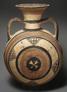 an old vase with geometric designs on it