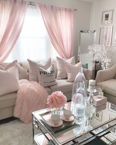 a living room filled with furniture and pink curtains