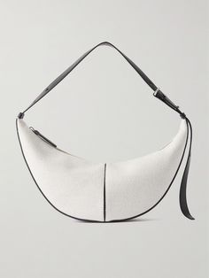 Proenza Schouler's 'Slide' bag is simple, timeless and functional, making it the perfect everyday style. Made from panels of leather and canvas in a crescent shape, it has an adjustable shoulder strap and features the label's new logo at the side. Store your phone, wallet and sunglasses inside. Designer White Baguette Bag For Everyday, Formal White Coated Canvas Shoulder Bag, White Leather Baguette Bag, White Bags With Leather Trim For Formal Occasions, White Formal Bag With Leather Trim, White Leather Trim Formal Bag, Formal White Bags With Leather Trim, White Leather Baguette Bag For Travel, Designer Leather Baguette Bag With Leather Handles