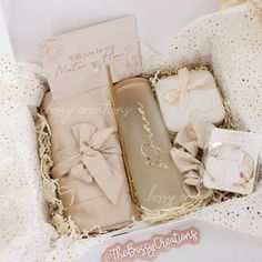 an open box with some wrapping paper and other items in it on a white surface