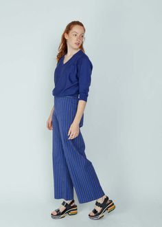 Bellerose's lottie trouser is crafted of a cotton blend and features a high waist fitted hip and wide leg.    details:    - zip and single button closure.  - high waisted. fitted hip. wide leg.  - minimal front pockets. rear pockets.  - belt loops.  - machine wash cool. line dry. dry clean.  - made in europe.    color blue stripe. 62% cotton 37% viscose 1% elastane. Slow Fashion Movement, Black Tank Dress, Black Aviators, Neon Purple, Baby Design, Ruched Dress, Sophisticated Style, Tank Dress, Slow Fashion