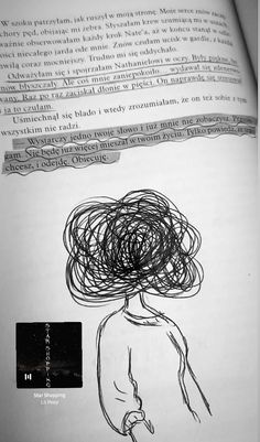 an open book with a drawing of a woman's head on top of it