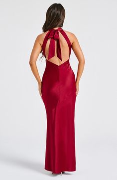 a woman in a red dress with a bow back