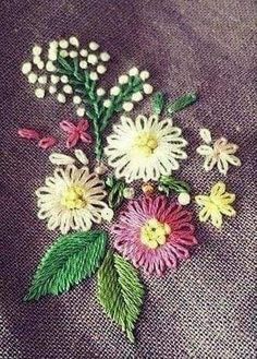 a close up of flowers on a cloth with white and pink flowers in the center