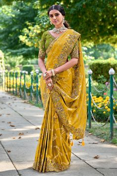 Fancy Silk Saree with blouse in Mustard and Yellow 6215 Get ready for Festive with our stunning Banarasi Silk Sarees. Each saree is a blend of tradition and contemporary fashion, designed to make you shineDesc:  Color : Mustard and Yellow Fabric :  Fancy silk saree Work :  embroidery   Blouse work: raw silk embroidery Wash Care : Dry clean Sleeve Style : Half Sleeve Long Sleeves : Done only in Custom Stitch Sleeves Lining : Done only in Custom Stitch Bust Size : 32 to 42 Inches Occasion : Wedding   Festival   Kitty Party   Sangeet   Party Wear   Engagement   Reception   Ceremonial. With Express Free Shipping and Custom Stitching, Buy Indian Party wedding and bridal Sarees Fancy Silk Saree with blouse in Mustard and Yellow 6215 online in USA, UK and Canada from KollyBoll Raw Silk Embroidery, Engagement Saree, Reception Saree, Saree Work, Mustard Yellow Color, Raw Silk Saree, Latest Designer Sarees, Sarees For Women, Yellow Saree