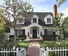 a white house with black shutters on the front