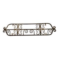 a metal shelf with scroll designs on it