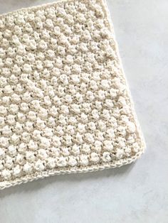 a white crocheted dishcloth on top of a counter