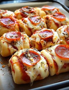 small pizzas with pepperoni and cheese on a baking sheet