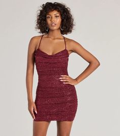 This sparkling glitter mini dress flaunts a cowl neckline and a revealing open back with a rhinestone embellished strap for a glam effect. Perfect for styling with heels for homecoming or a birthday.Fit & FeaturesGlitter fabric, sewn-in knit lining, moderate stretchCowl neckline, padded bra cupsAdjustable spaghetti straps, crisscross backOpen back, rhinestone embellished strapSide ruched seamsBodycon mini-length silhouetteRuns true to size Glamorous Mini Dress With Cowl Neck For Night Out, Glamorous Cowl Neck Mini Dress For Night Out, Glamorous Cowl Neck Mini Dress For Party, Glamorous Evening Mini Dress With Cowl Neck, Glamorous Cowl Neck Dress For Night Out, Glamorous Fitted Cowl Neck Dresses, Sparkling Mini Bodycon Dress For Date Night, Backless Mini Dress For Holiday Party, Glamorous Cowl Neck Dress For Party Season