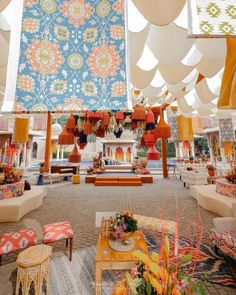 a room filled with lots of colorful furniture and hanging decorations on the ceiling above it