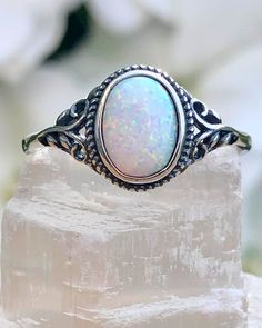 Sterling Silver Oval White Lab Opal Ring | The Life Divine Sterling Silver Oval White Lab Opal RingCherished for its brilliance, Opal is known as a stone of creativity and vitality. Opal is also a reflective stone of protection, absorbing energies and sending them back to their source.Measures approximately 3/8" H x 1/2" W Silver And Opal Ring, Adjustable Oval Spiritual Rings, Adjustable Opal Crystal Ring, Oval Shape, Adjustable Opal Oval Crystal Ring, Adjustable Oval Opal Crystal Ring, Spiritual Oval Stone Setting Jewelry, White Oval Opal Crystal Ring, Bohemian Opal Ring With Oval Stone Setting, Bohemian Oval Opal Ring For Gift