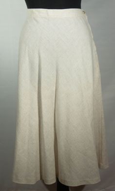 This is a fresh, original and unique rayon, flax and polyester off white, ecru A line boho 1970's vintage Sears label midi skirt. This vintage wardrobe staple, keeper of a neutral skirt is very well constructed. It has a high waist band and hidden zipper and button closure with a hemline that falls below the knees. It also has a wonderful leisure boho 70s look and the great collectible vintage SEARS label. It is in great pre-loved vintage condition with normal signs of wear/use and no major dama Spring Bohemian A-line Bottoms, Bohemian A-line Summer Bottoms, White Linen Knee-length Bottoms, White Knee-length Linen Bottoms, Classic Off White Bottoms For Spring, Bohemian A-line Bottoms For Summer, Spring Beige Flax Bottoms, Spring A-line Bohemian Bottoms, Bohemian A-line Bottoms For Spring