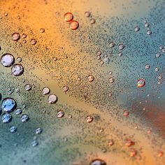 drops of water are seen on the surface of a liquid filled glass window pane