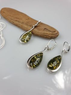 You can choose Earrings or a pendant. This Set is made of natural green Amber and Sterling Silver 925. With all hallmarks. All parts are sterling silver. Stunning elegant, not to small earrings, length about 4,5 cm https://www.etsy.com/shop/AmberLithuania?ref=simple-shop-header-name&listing_id=780205095&section_id=27948198 Green Sterling Silver Drop Jewelry, Green Drop Sterling Silver Jewelry, Green Long Drop Sterling Silver Jewelry, Green Teardrop Pendant Jewelry With Matching Earrings, Green Sterling Silver Pendant Earrings, Green Sterling Silver Teardrop Earrings Gift, Hypoallergenic Amber Dangle Earrings, Green Sterling Silver Teardrop Earrings, Amber Sterling Silver Hypoallergenic Earrings