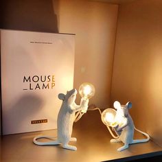 two white mouse lamps sitting on top of a table