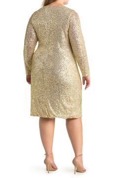 Sparkle the night away in this sequin wrap mini dress that features a flattering ruched design and long sleeves. 40" front length; 44" back length (size 1X) Surplice neckline Wrap front Long sleeves Back zipper closure Lined 95% nylon, 5% spandex Hand wash cold, lay flat to dry Imported Model stats: 5'10", 41" bust, 36" waist, 48" hip. Model is wearing size 1X. Gold Party Dress Short, Gold Party Dress, Wrap Mini Dress, Surplice Neckline, Gold Party, Party Dress Short, Mini Wrap Dress, 50's Dress, Lay Flat